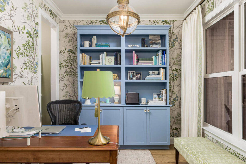 Custom home office with blue built-in bookshelves and wallpaper in Chattanooga, TN