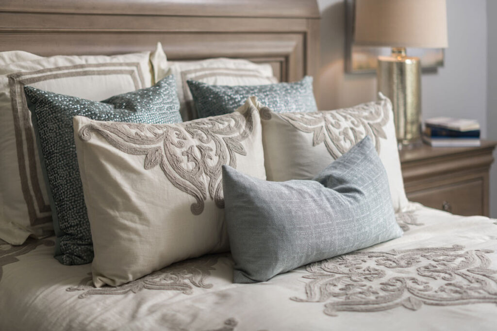 Custom bedding and decorative pillows, interior design by Chattanooga Window Treatments